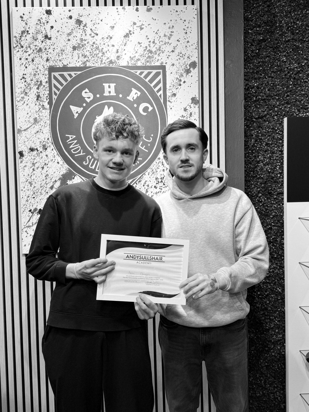 Andy presenting a graduate with his AndySullsHair Academy certificate