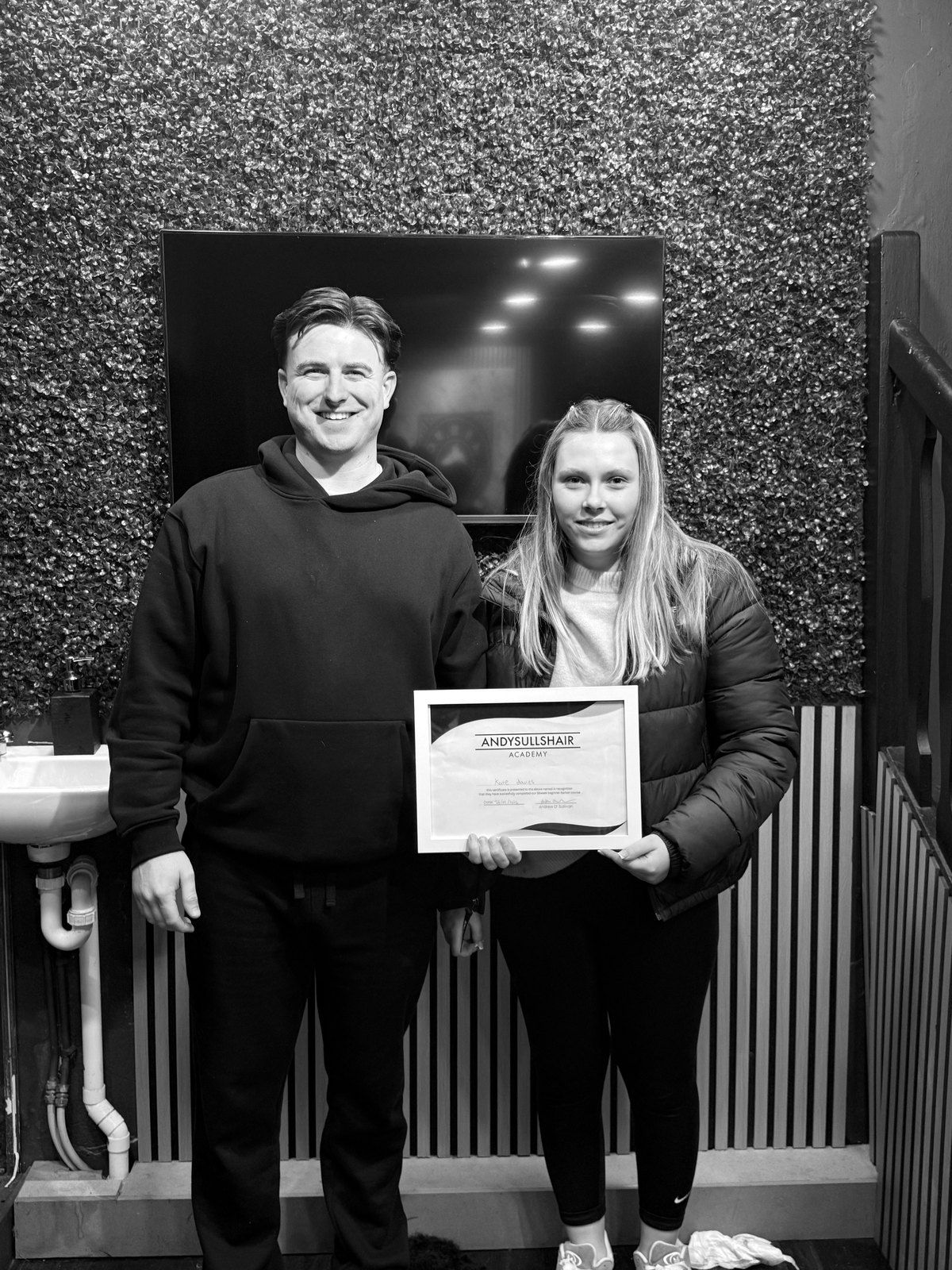 Andy with a graduate holding her AndySullsHair Academy certificate