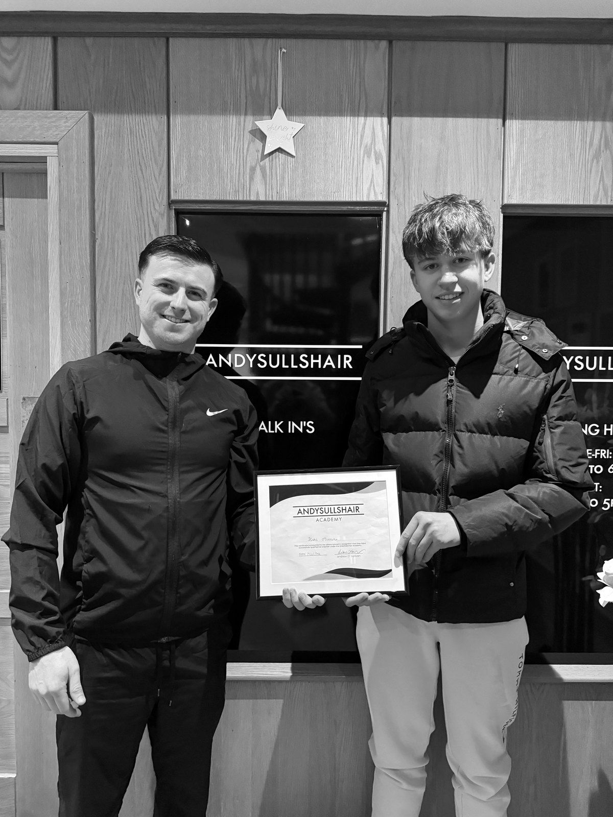 Andy and a graduate with his certificate at the Lancaster Quay shopfront
